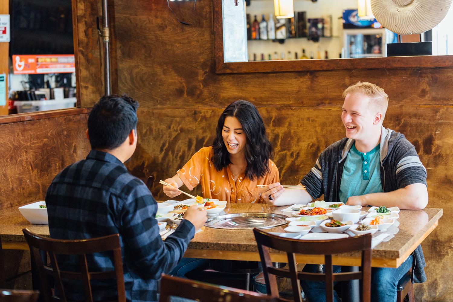 Young people eating at a Korean BBQ restaurant 