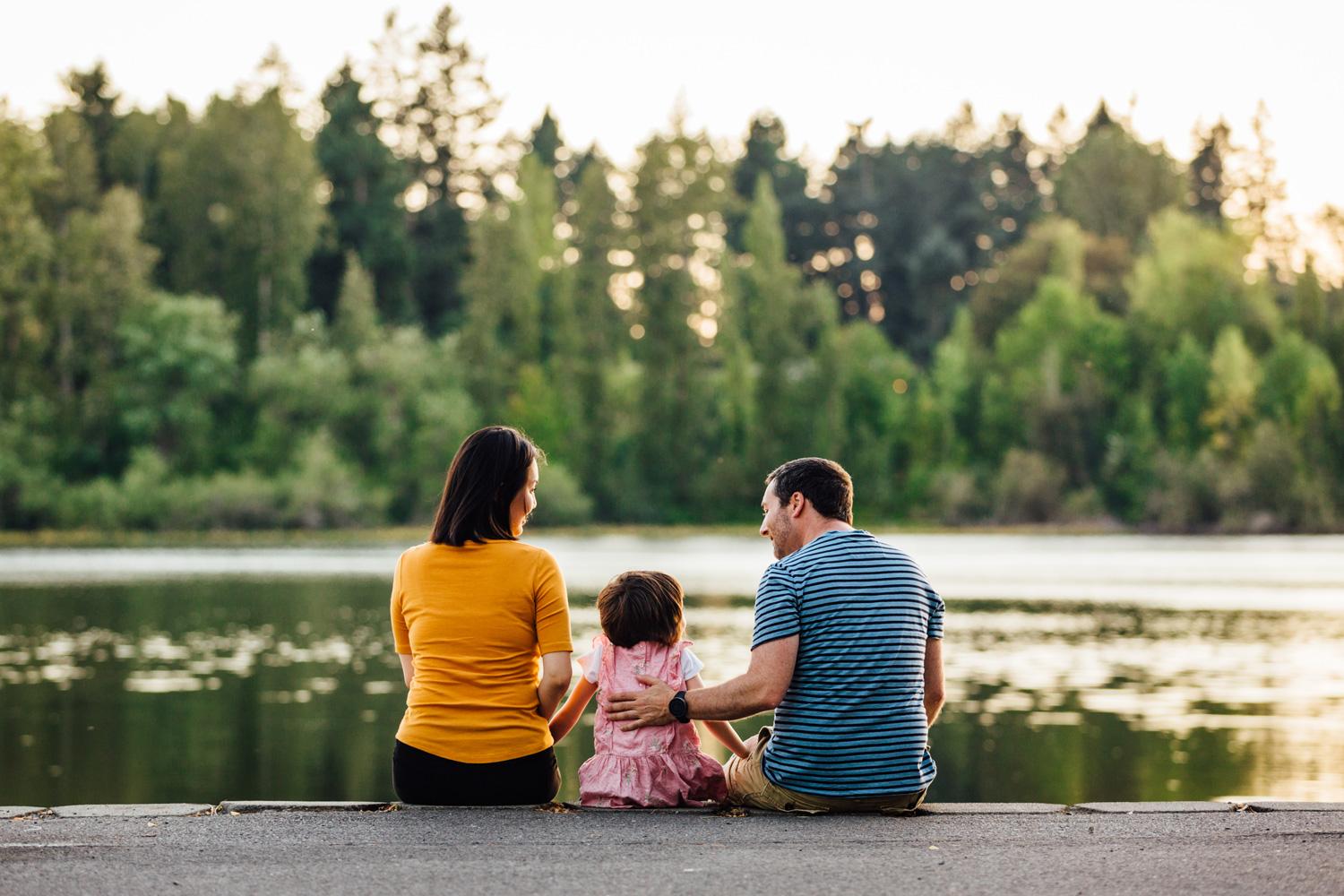 Family sitting by a lake in Lakewood, WA